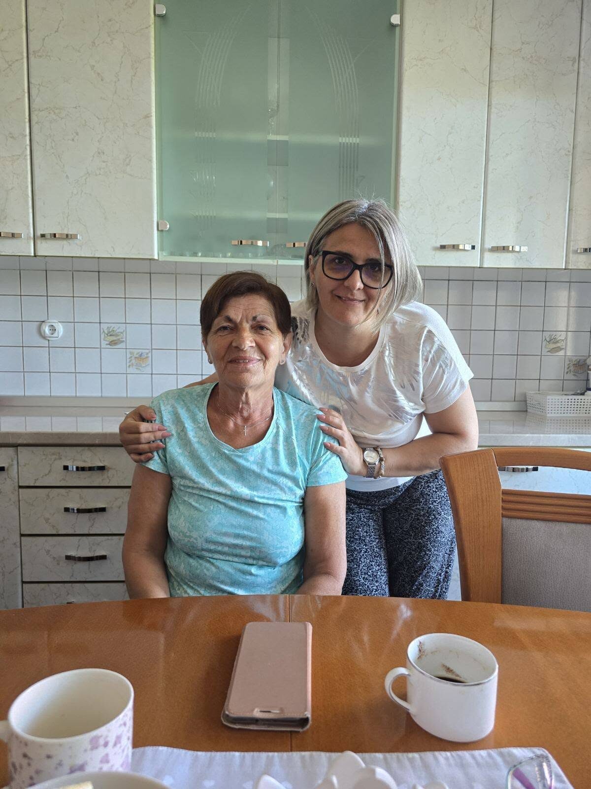 Two women of different generations at a kitchen table